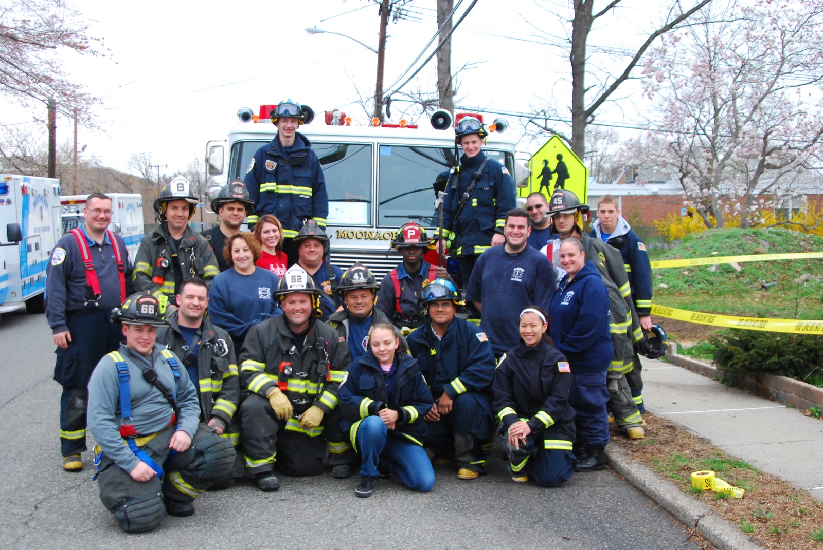 Group photo of Moonachie firefighters in front of an engine