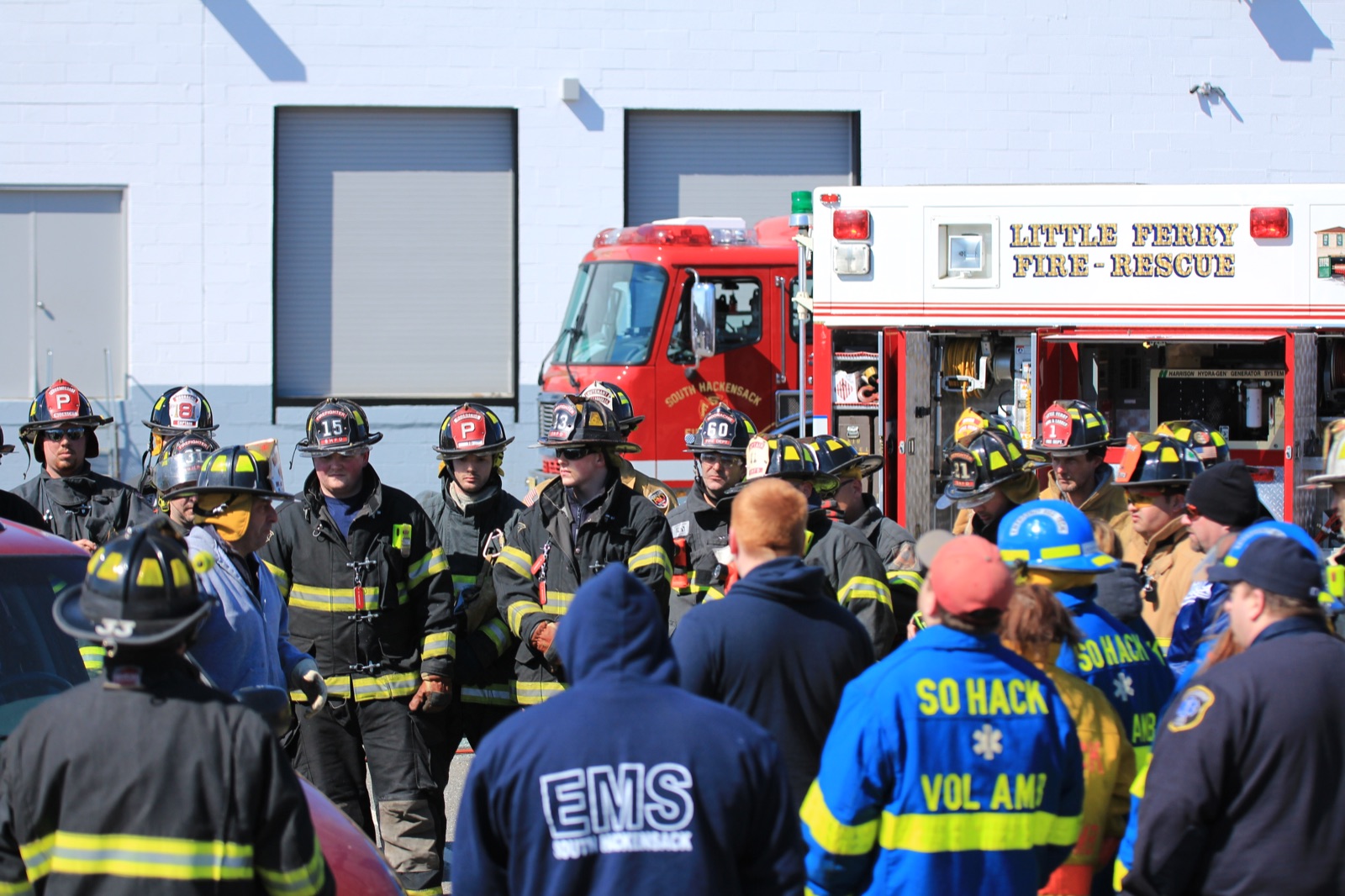 Firefighters and EMS from neighboring departments staged with apparatus